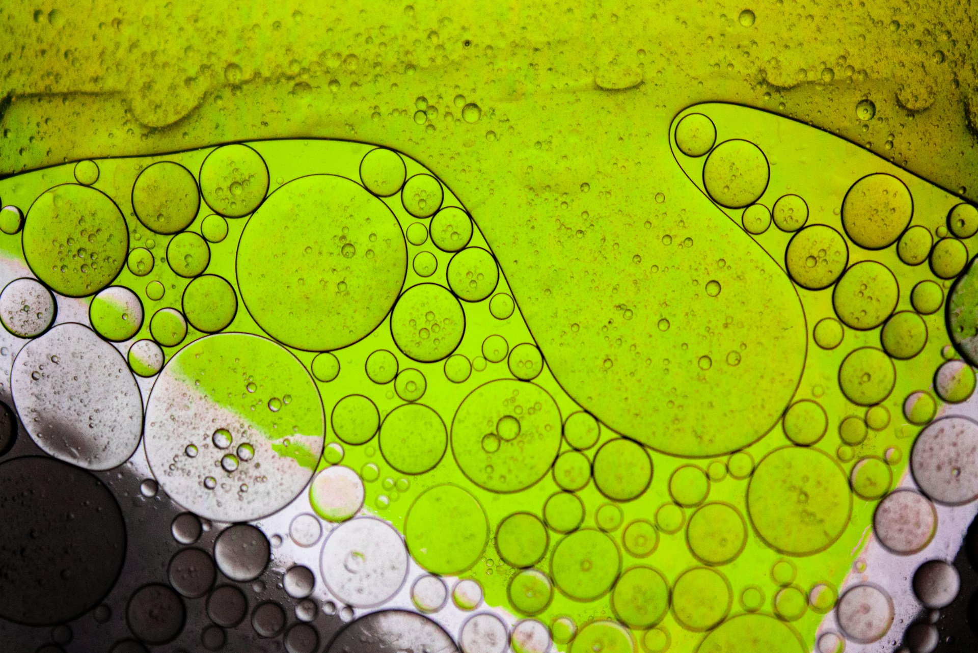 Macro photograph of green and amber microbubbles