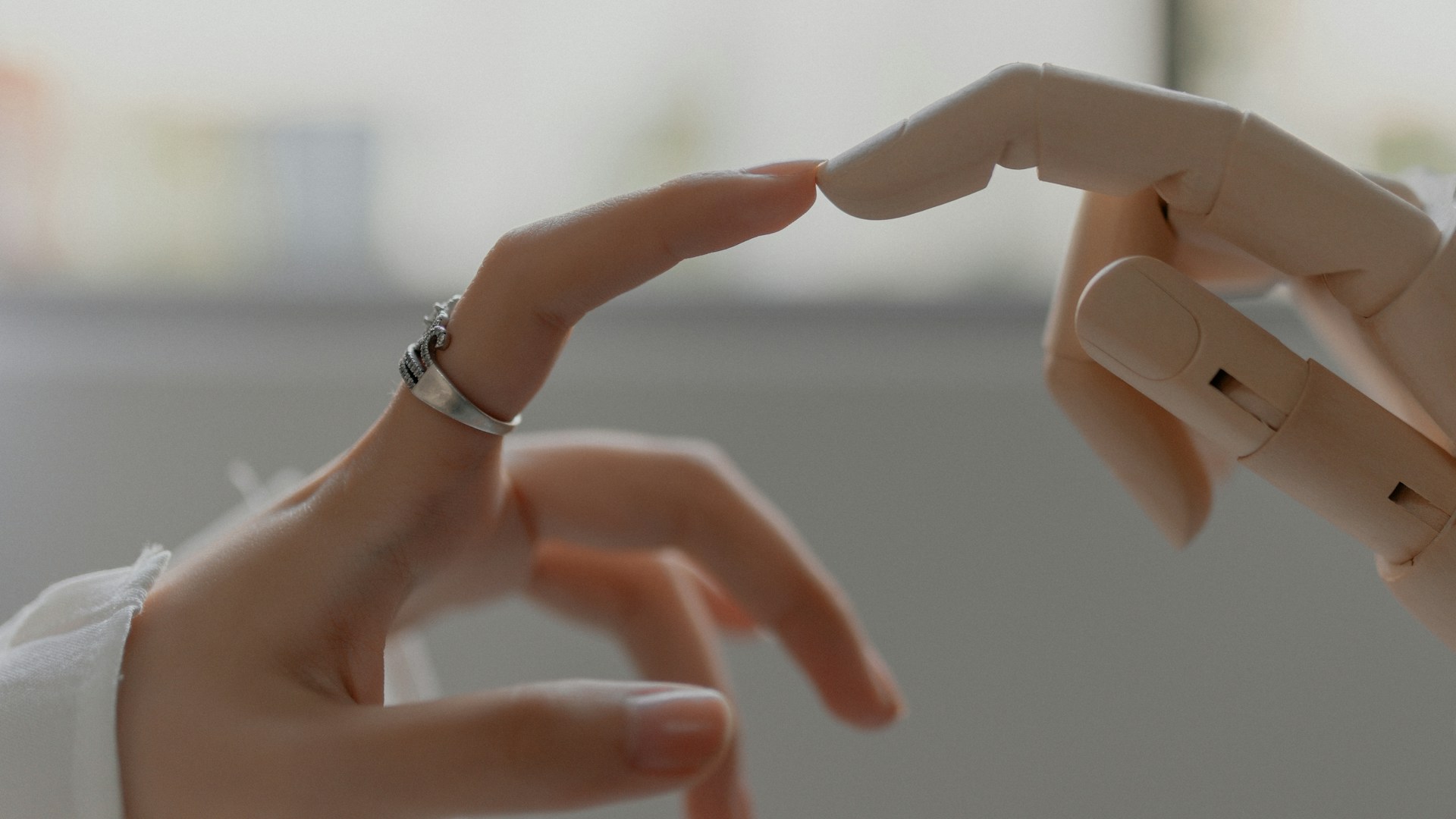A human hand reaching toward a robotic prosthetic hand